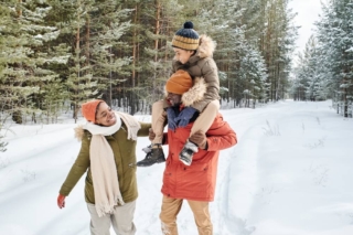 Family walking through snowy trail during winter in Lake George NY